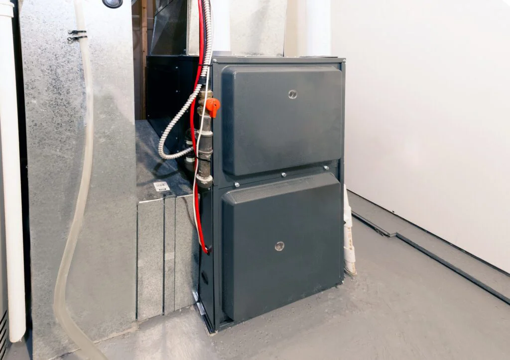 A modern, dark gray HVAC furnace unit